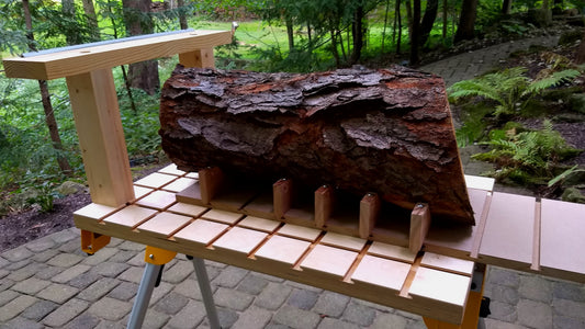 A rough log cradled in two-piece adjustable V-blocks on a Hornbeam T-slot grid worktop