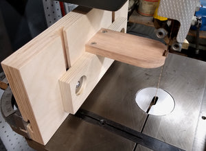 A bandsaw template-following jig uses WoodAnchor fixturing slots to provide two-axis of follower adjustments