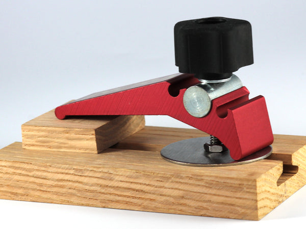 A WoodAnchor Female Knob Clamping Kit in 2-1/2" fixed mounting post configuration, used with a hold-down clamp