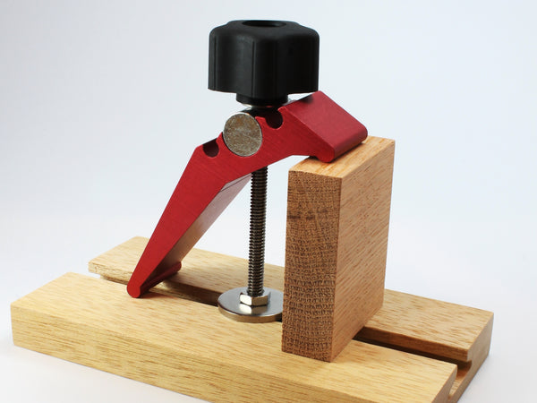 A WoodAnchor Female Knob Clamping Kit in 4" fixed mounting post configuration, used with a reversed hold-down clamp